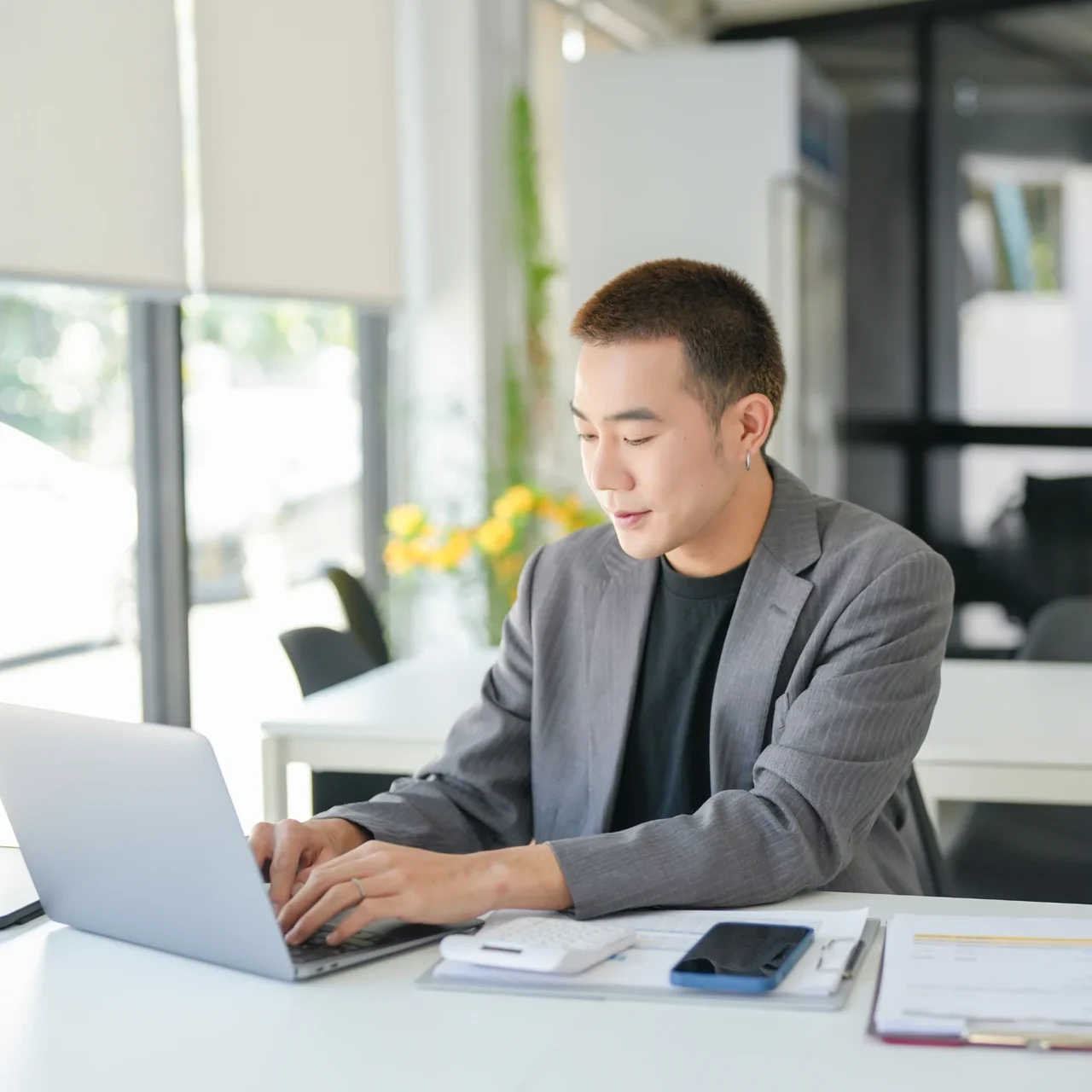 Professional working on a laptop at a desk.