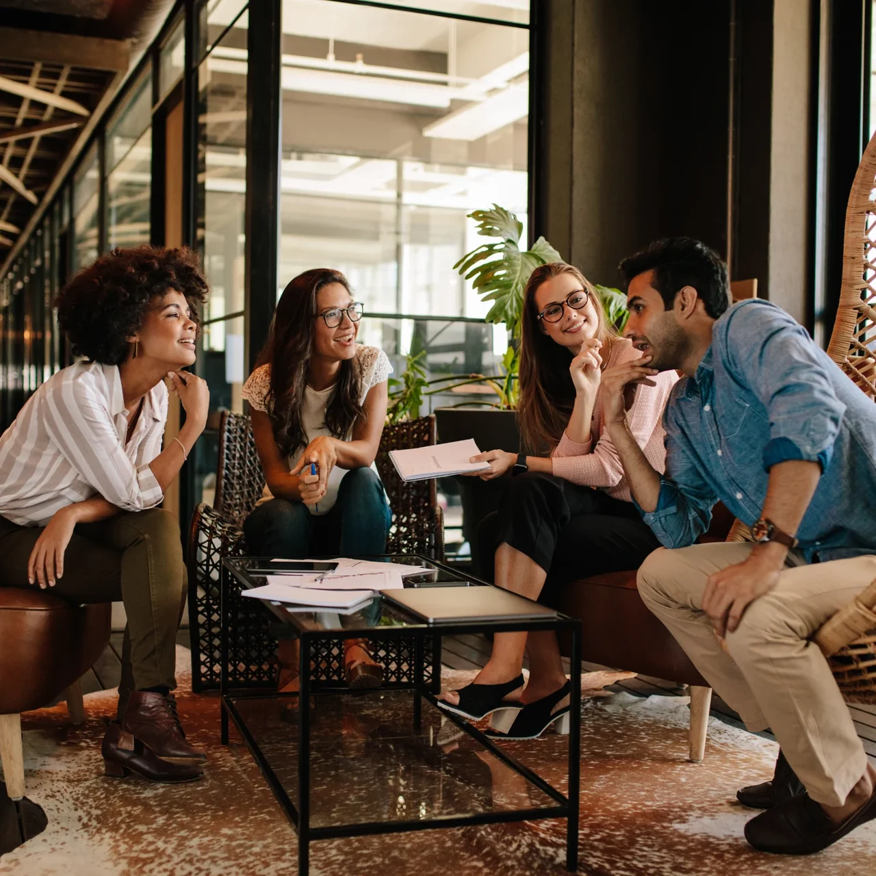 Colleagues discussing ideas in a casual workspace.