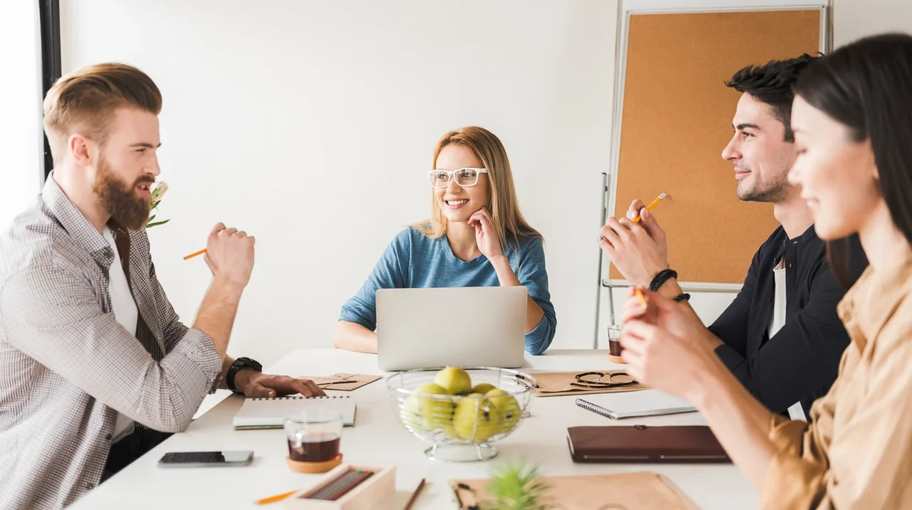 A team discussing ideas around a meeting table.