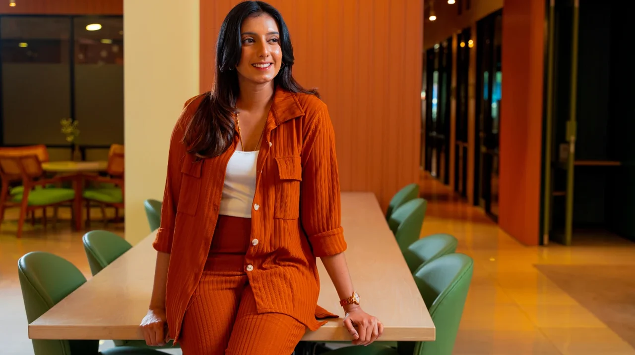 Professional in an orange suit in a warm and colorful workspace.