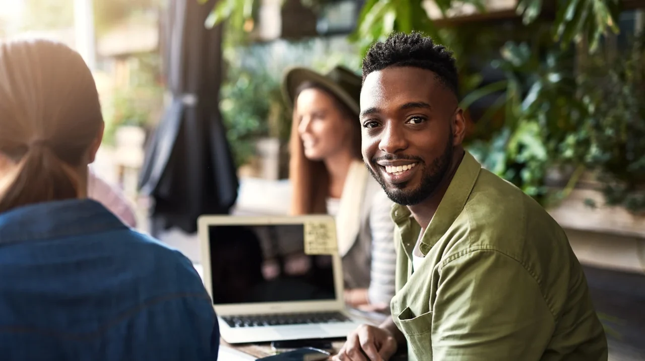 Professional smiling during a conversation at work.