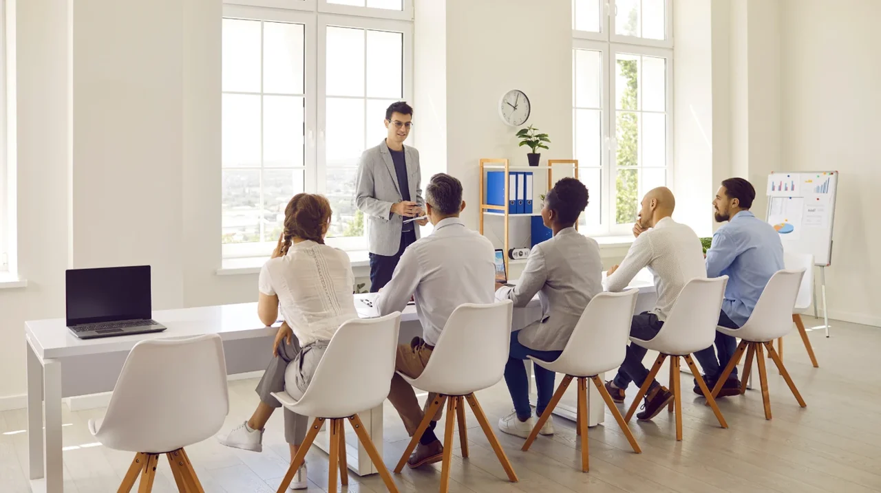 Professional leading a discussion in a training room.