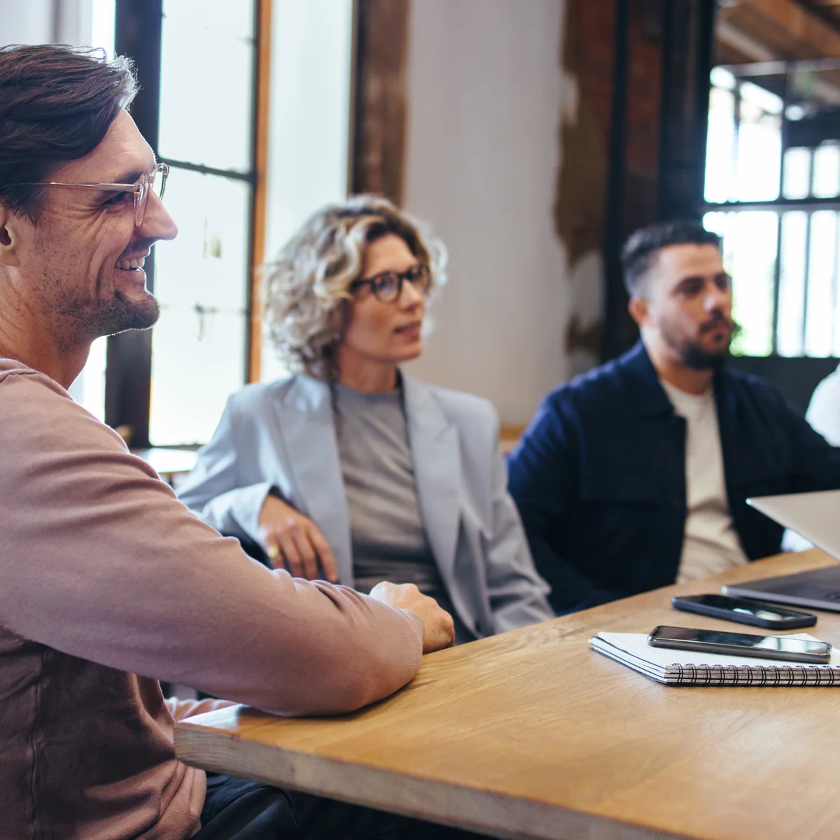 Colleagues reviewing information together at a meeting table.