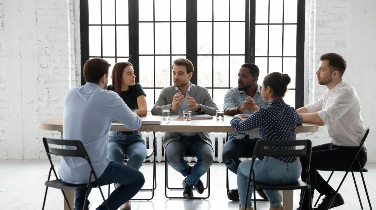 Colleagues discussing ideas around a table.