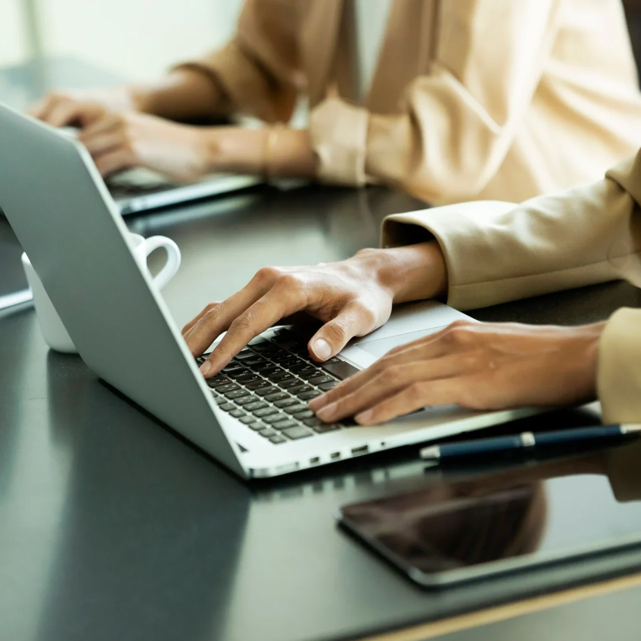 Hands typing on a laptop.