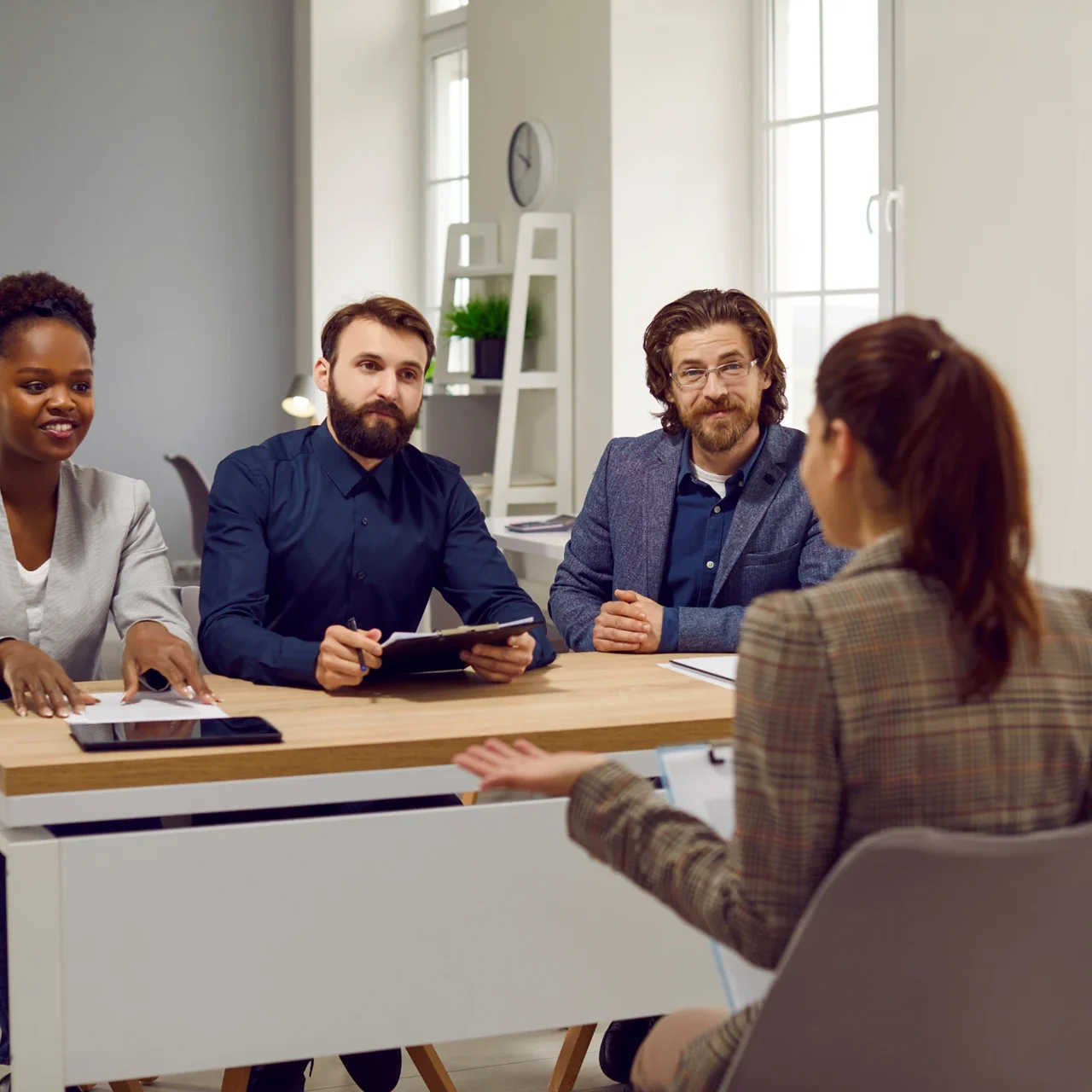 Colleagues listening to a speaker at a meeting.