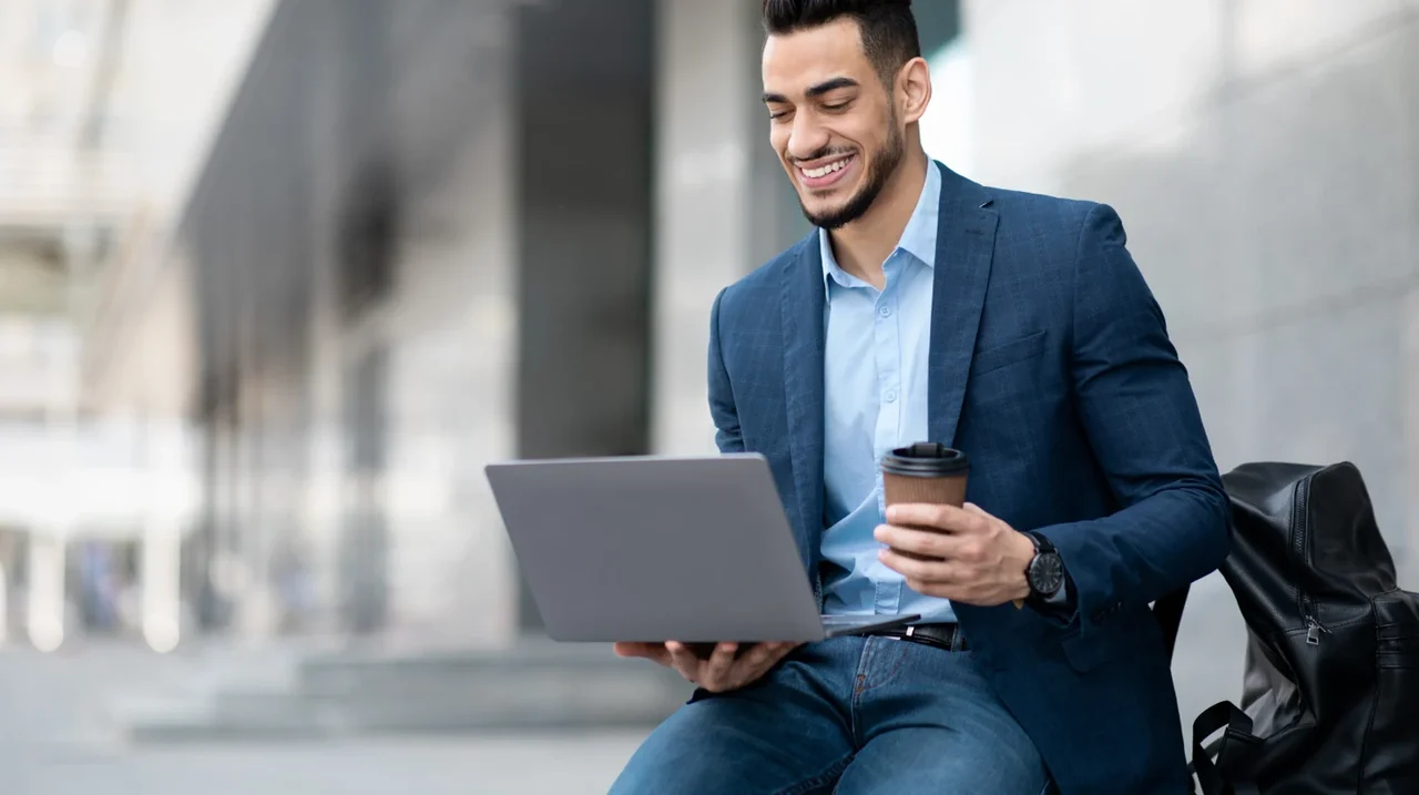 Professional working on a laptop outdoors.
