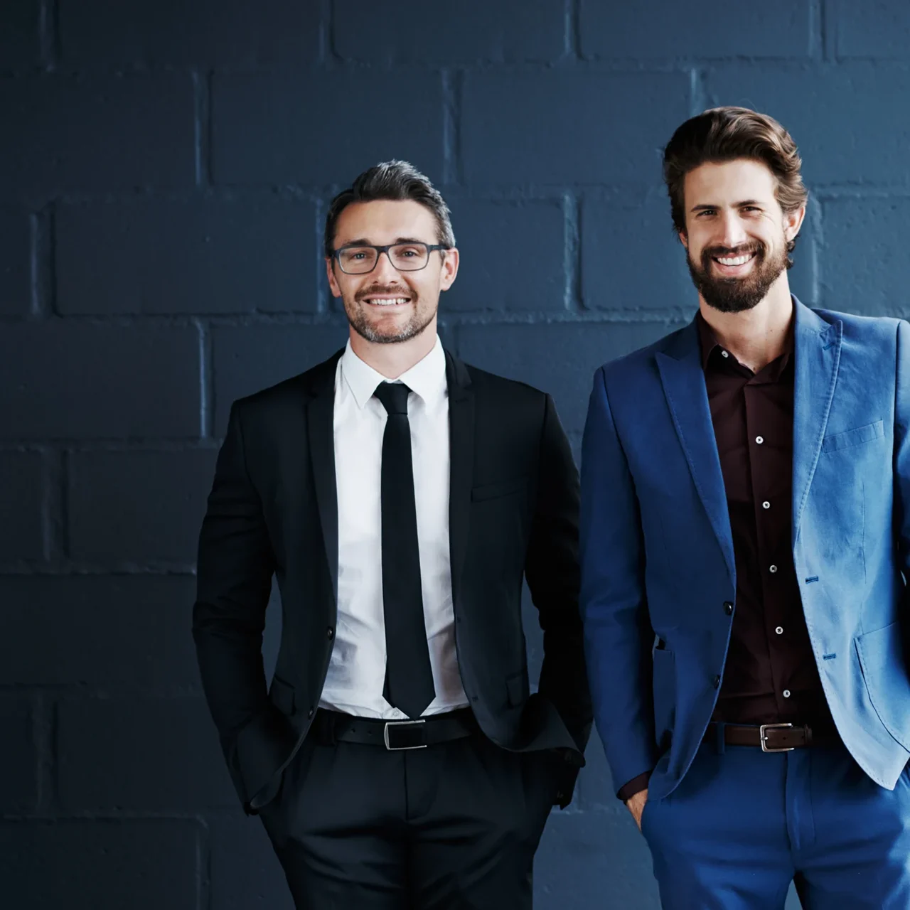 Two professionals smiling in a modern office.