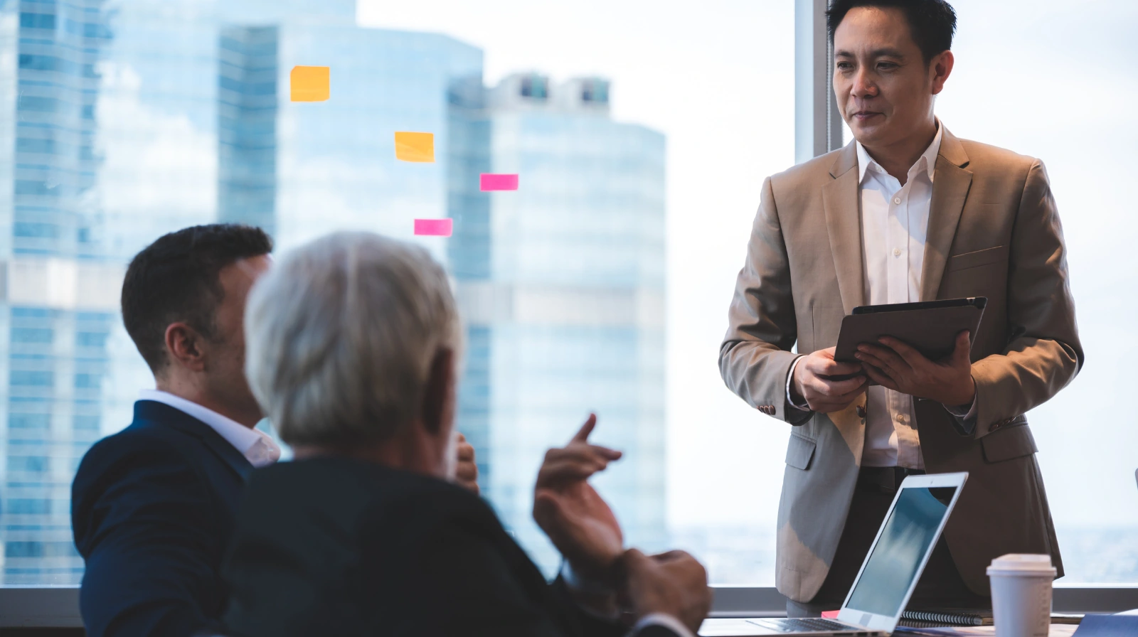 A professional explaining information to colleagues in a meeting.