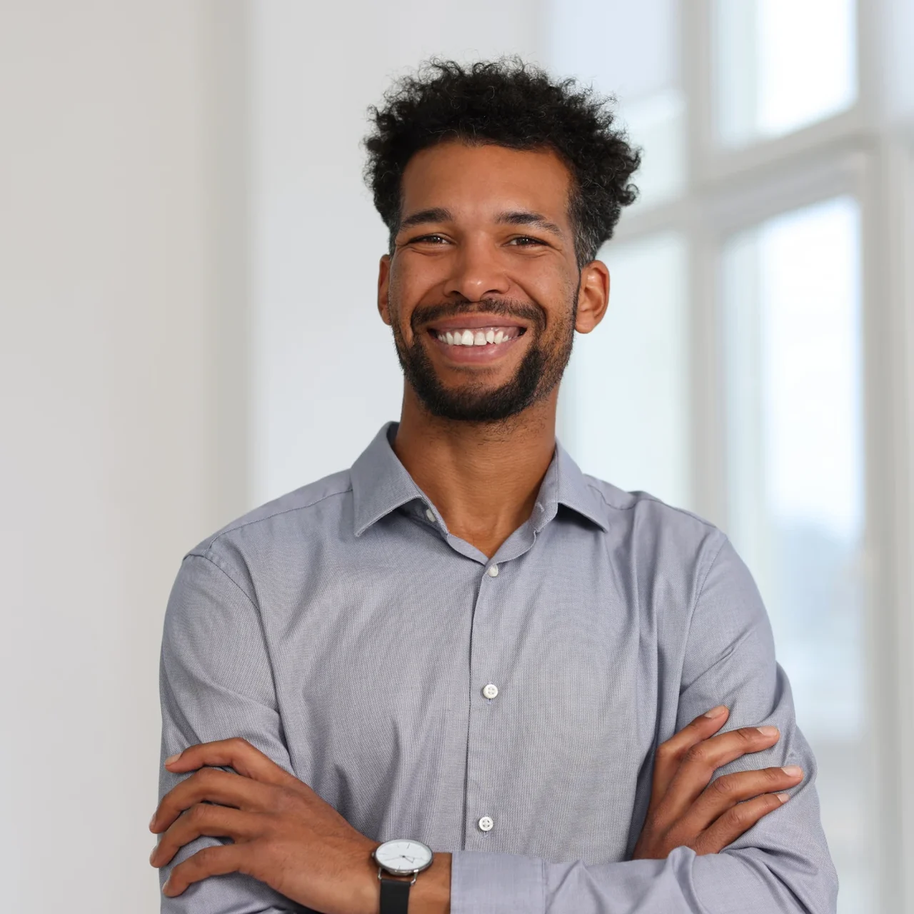 Professional smiling in a bright workplace.