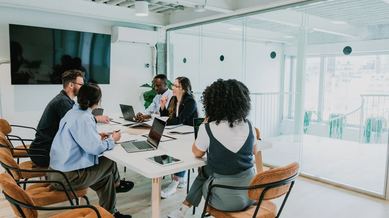 Colleagues collaborating around a meeting table.