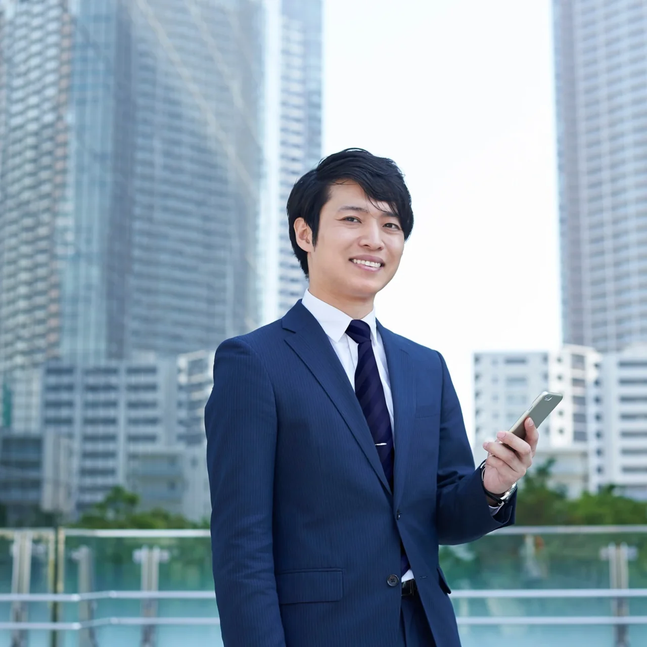 Professional holding a tablet outside a city office.