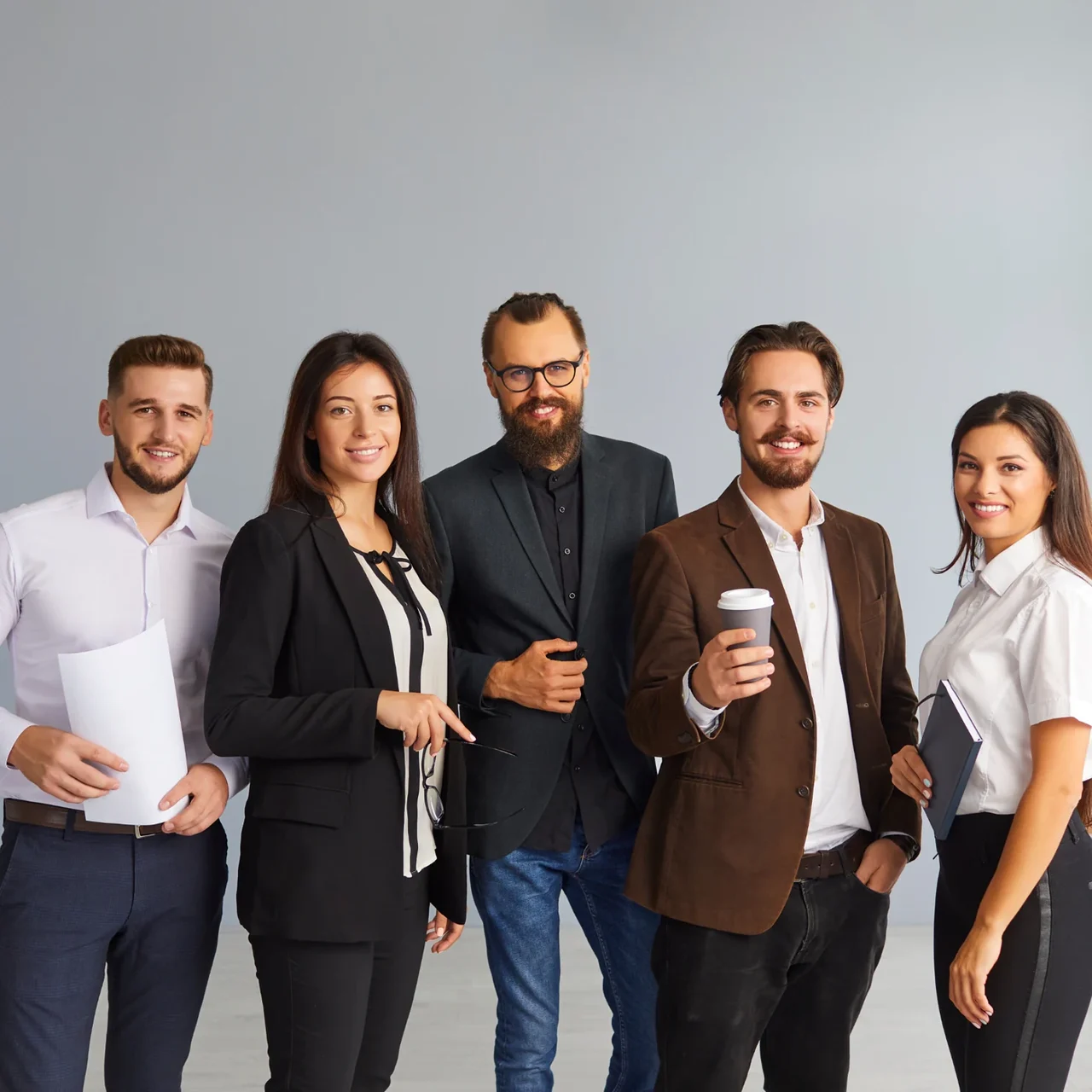 Five colleagues standing together.