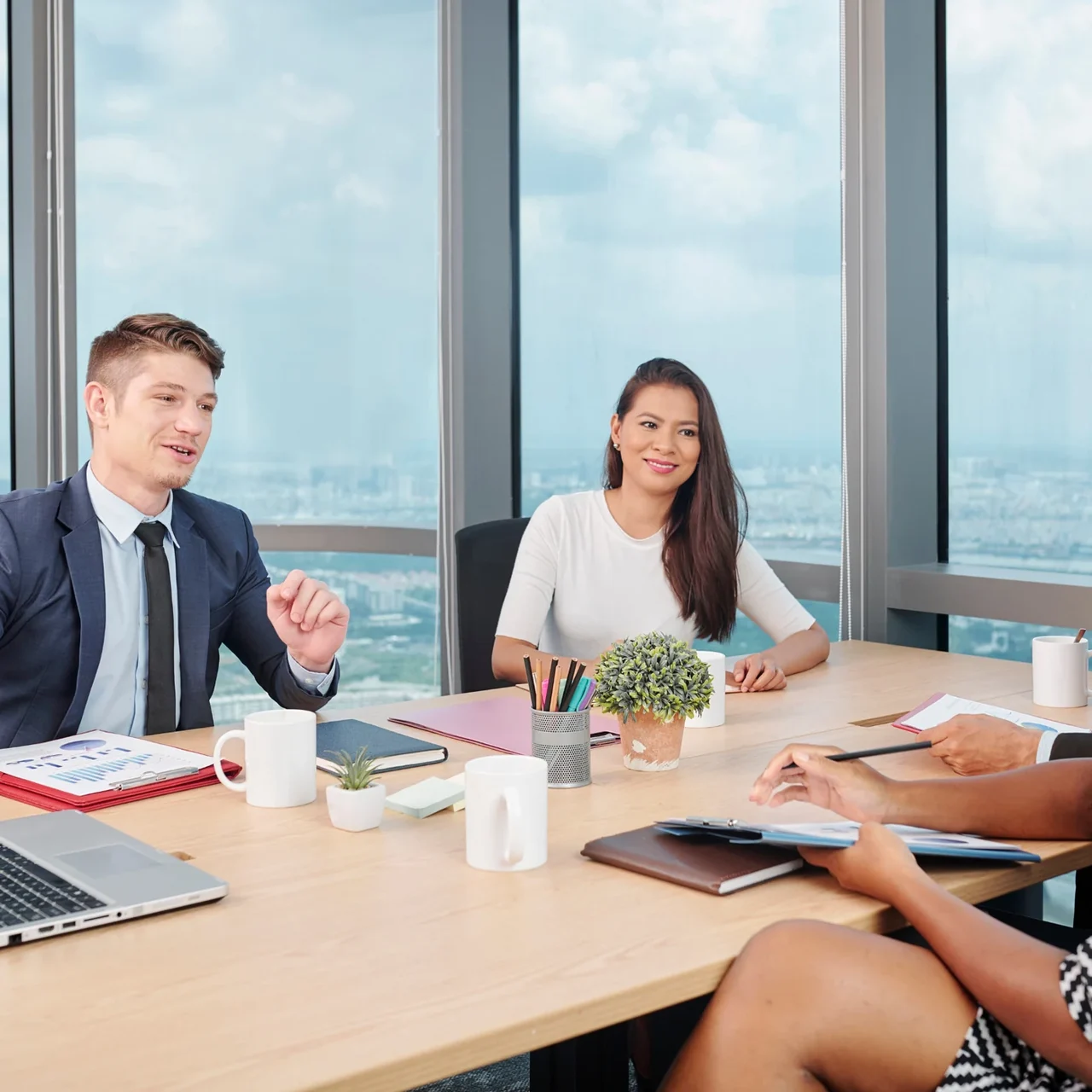 Colleagues discussing work around a conference table.