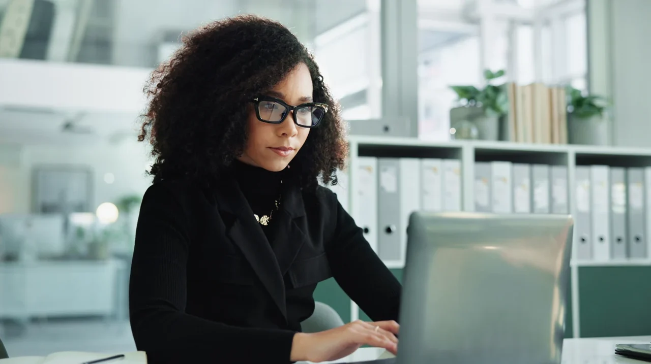 Professional concentrating on a laptop.